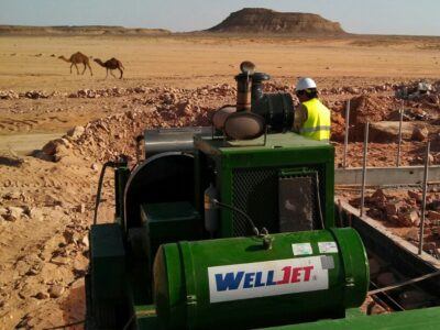 camels walking past work site in Jordan.