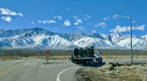 Welljet truck on the way to a job site with snow-covered mountains in the distance.